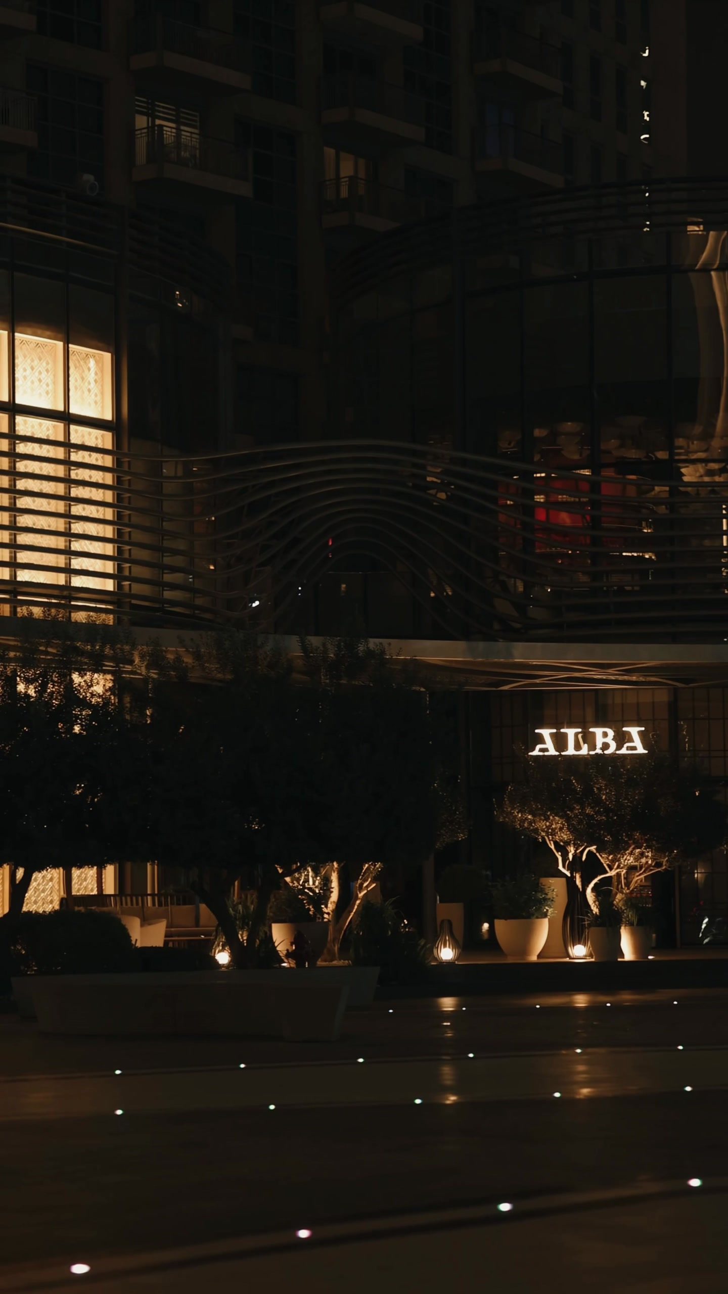 An evening at Alba: the Burj Khalifa through the window, the open counter, and the room filling up.,أمسية في ألبا: برج خليفة من النافذة، والكاونتر المفتوح، والغرفة تمتلئ.