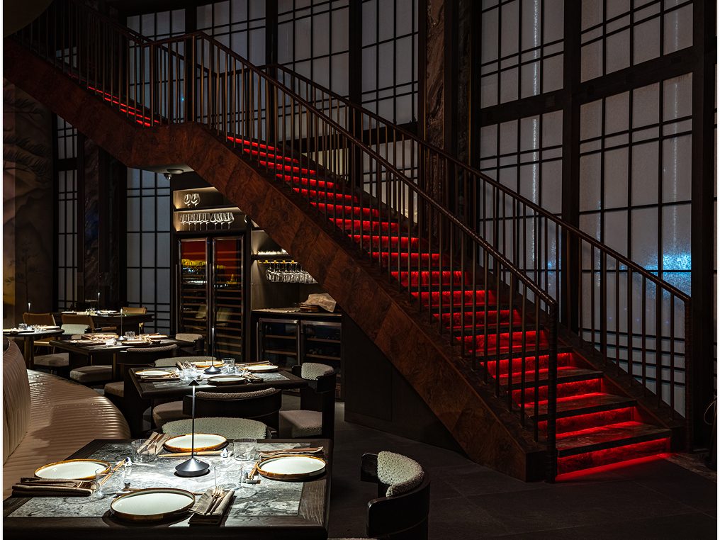 The red staircase at Alba, seen across a set table.