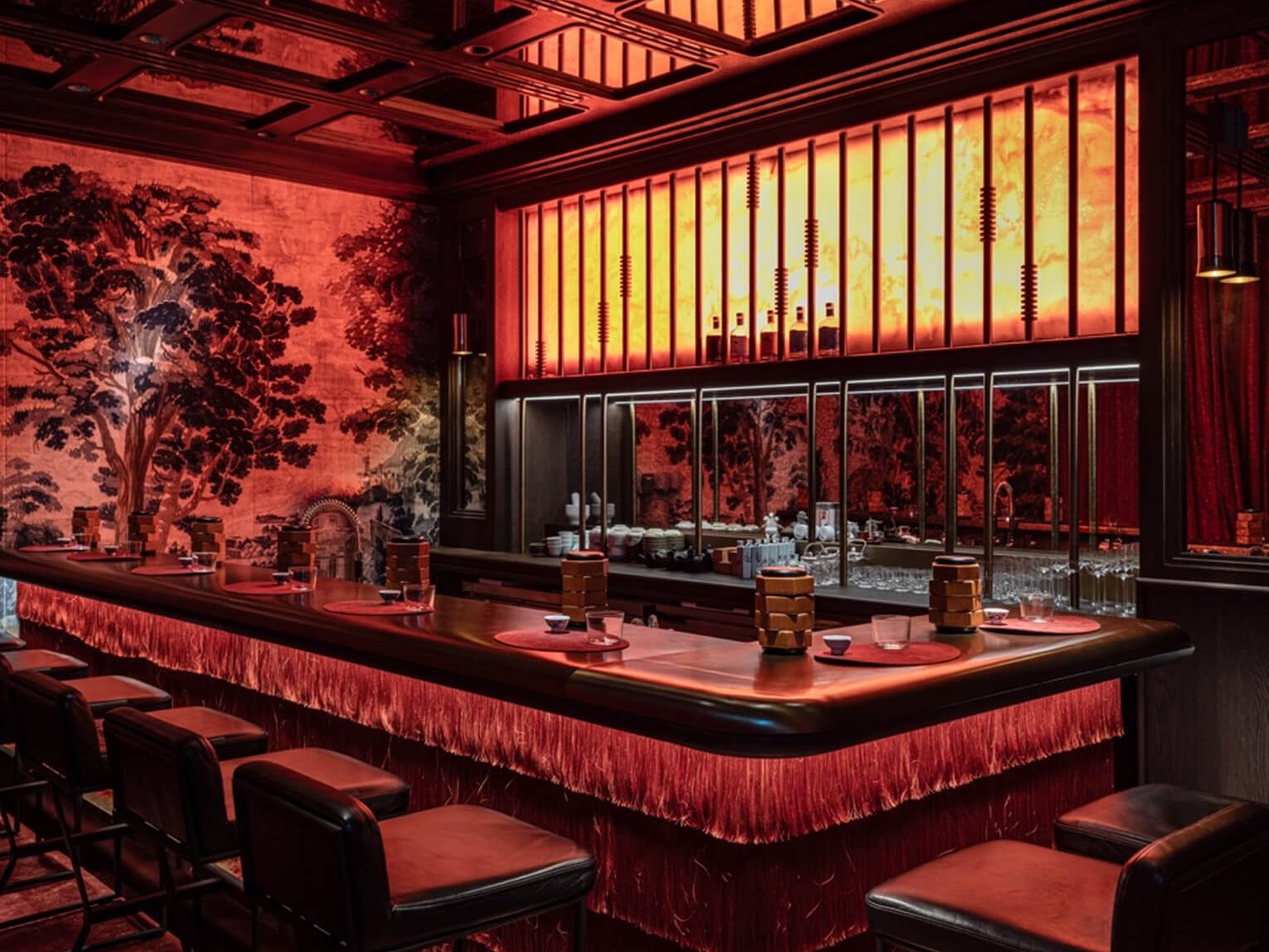 The circular bar inside the Alba building, lit red beneath hanging lanterns.