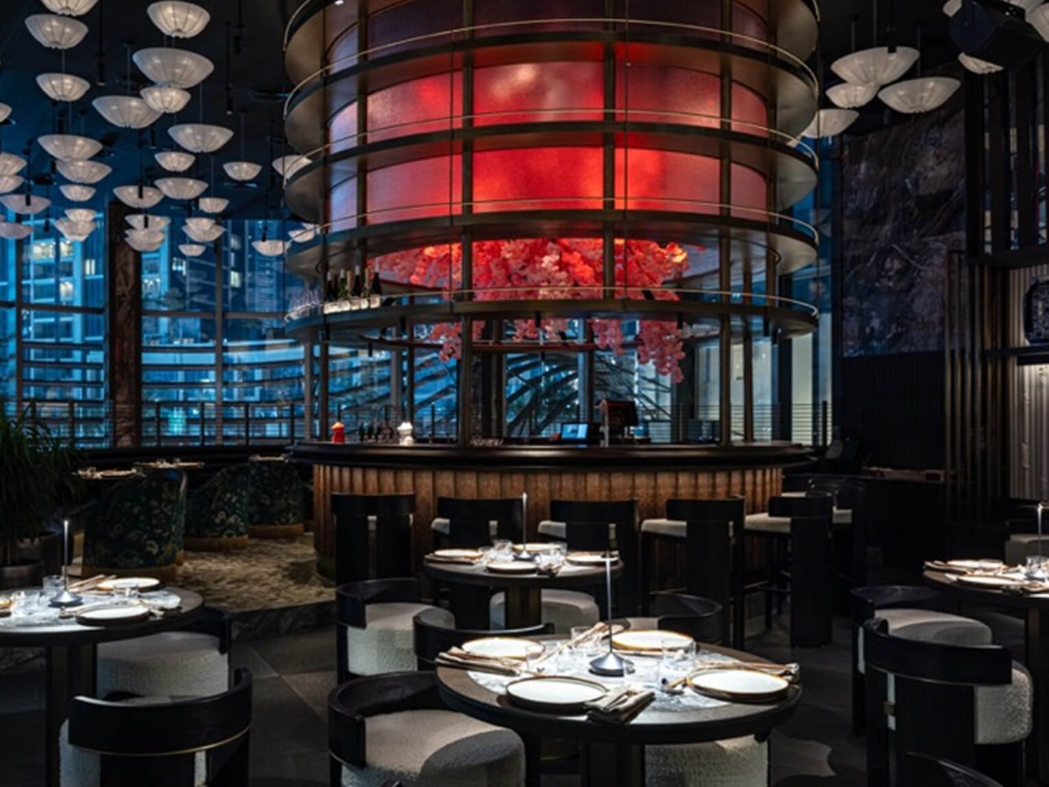 The dining room at Alba, tables set beneath its lantern chandelier.
