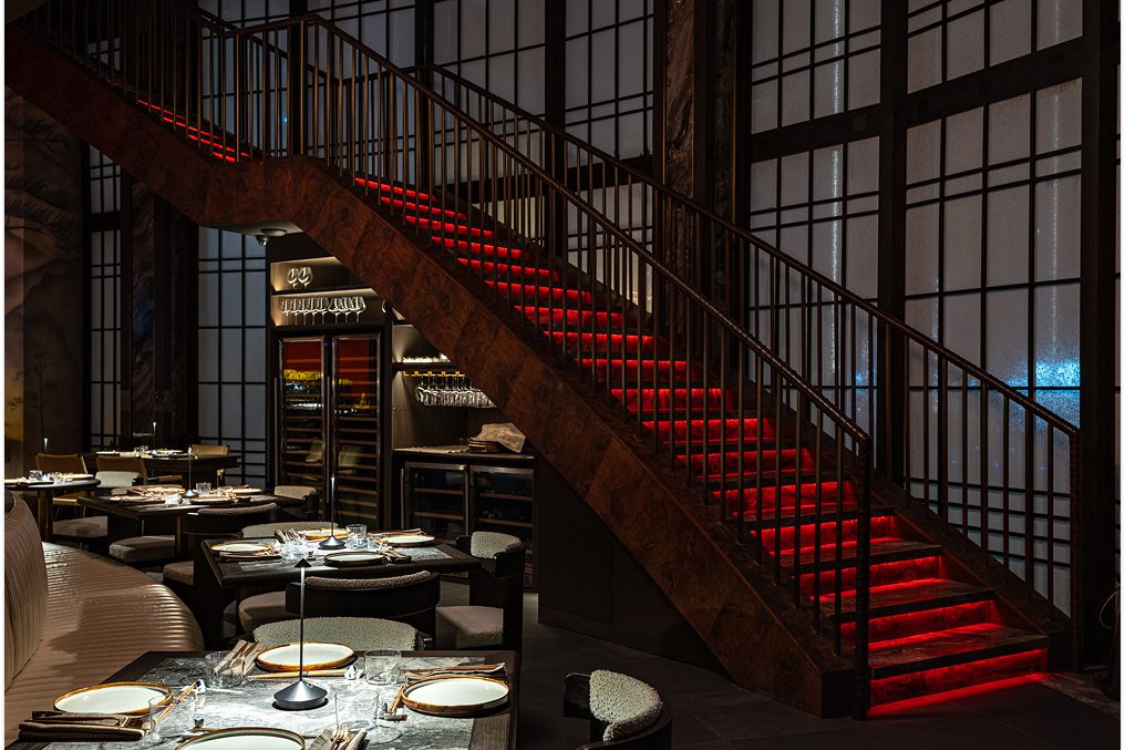 The red staircase at Alba, seen across a set table.