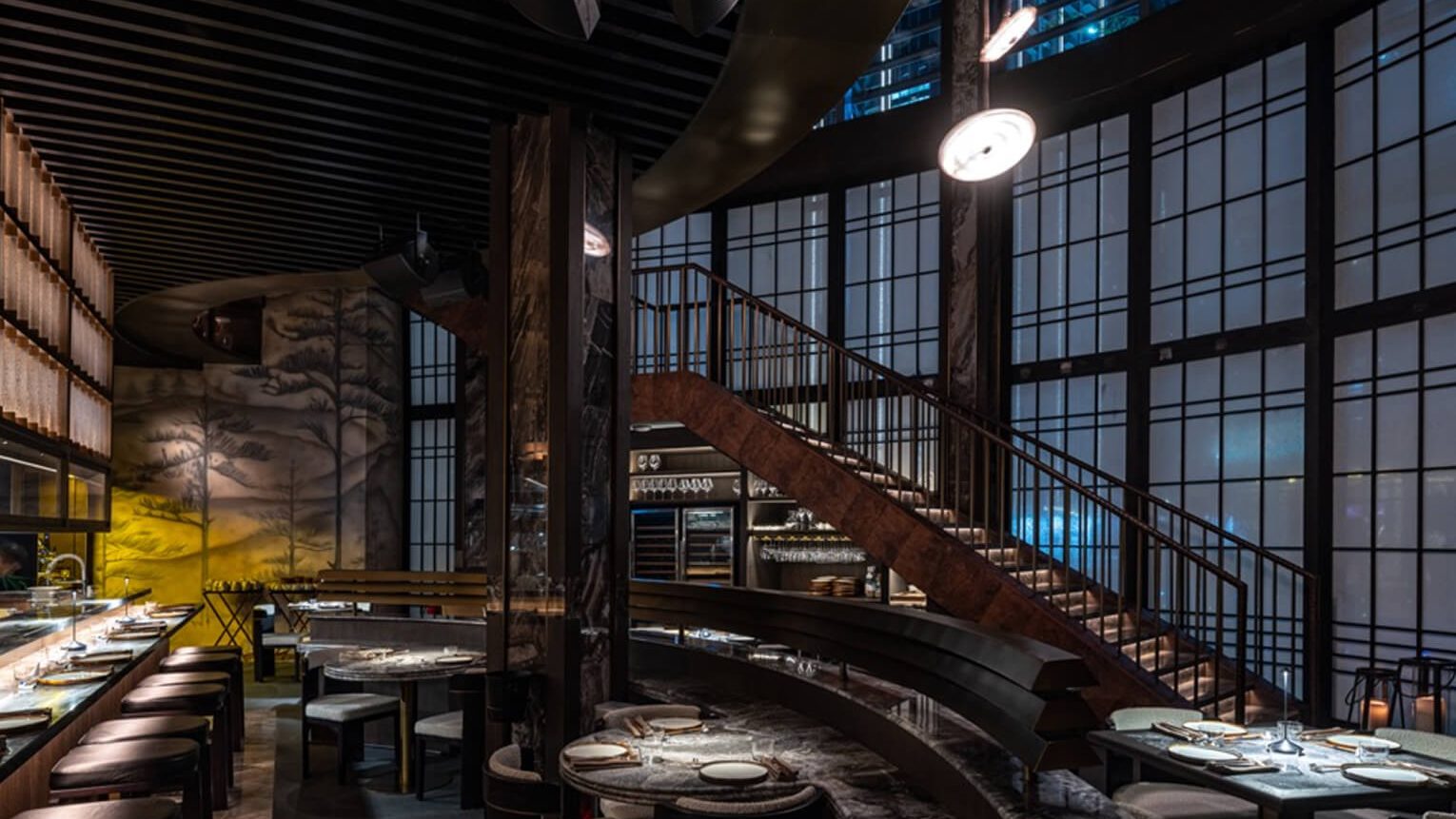 Alba's dining room seen from above, its staircase curving down past the windows.