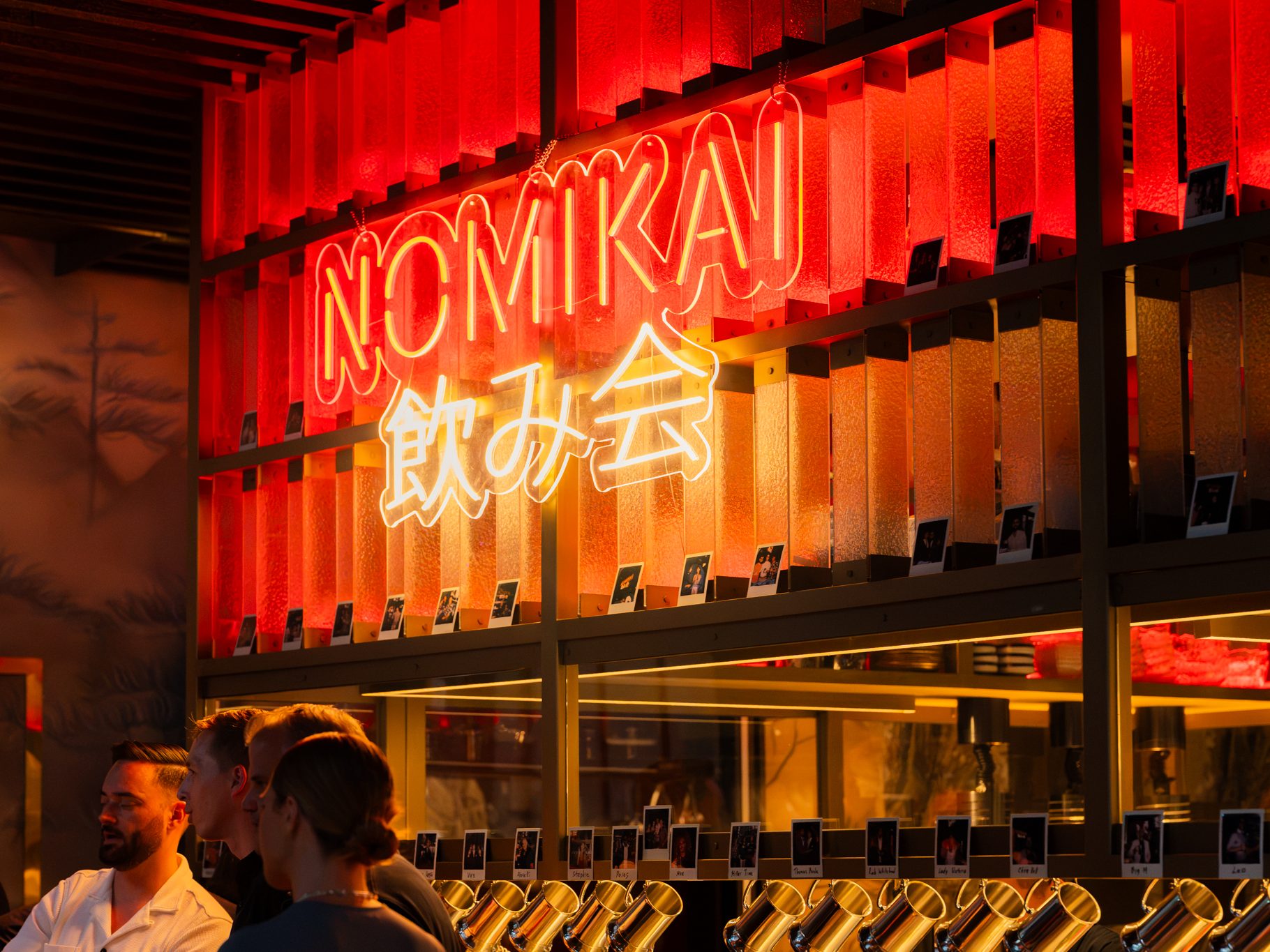 A red-lit counter and stools on the ground floor at Alba.